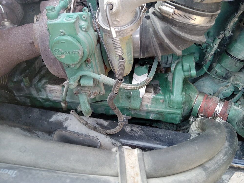 Volvo diesel engine bay during a repair, turbo and exhaust plumbing visible