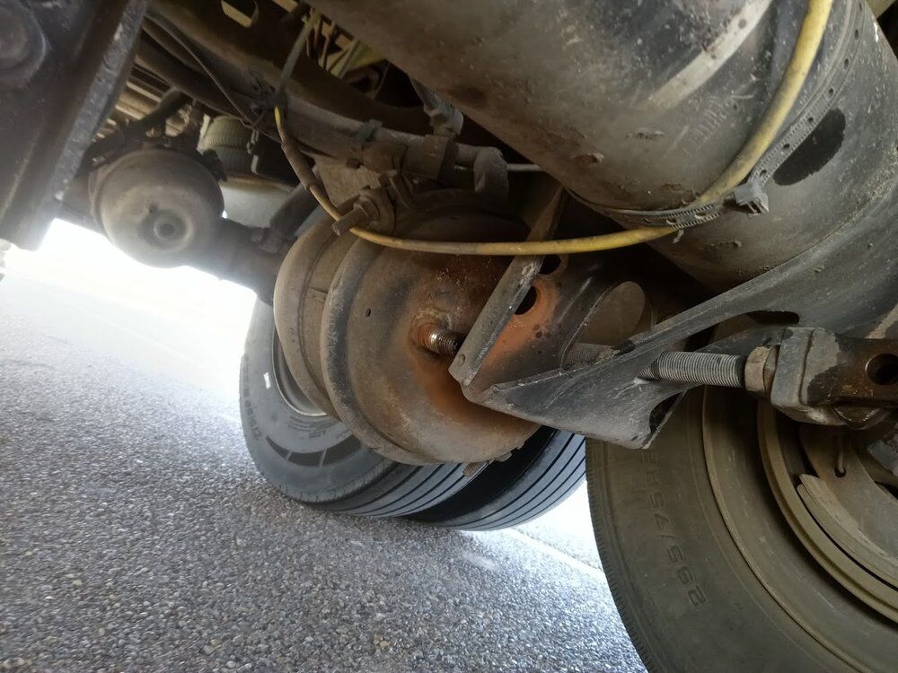 Drive axle and suspension viewed from under a tractor during a roadside inspection