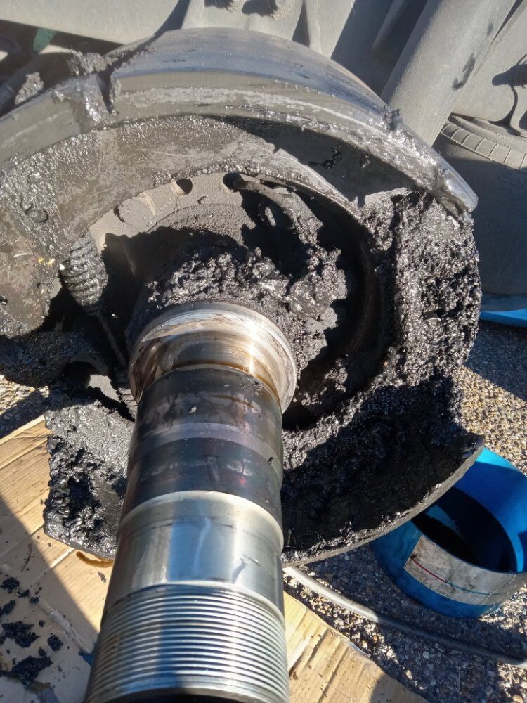 Failed wheel spindle and bearing race packed with burnt grease
